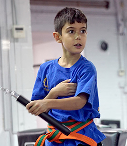 A student using a nunchaku during training at NYMAA