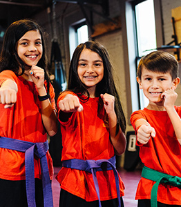 Three children in fight stance at NY Martial Arts Academy