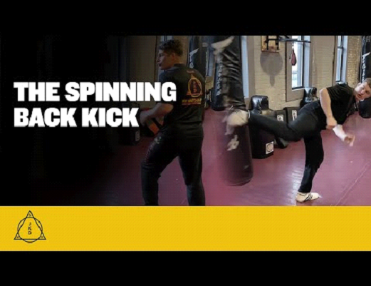 A martial artist demonstrates a spinning back kick.