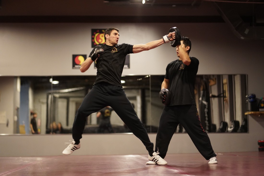 Martial artist using lead step with straight punch